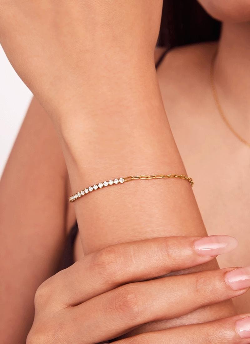 model wearing an elegant half-crystal tennis bracelet in gold plating by Elra