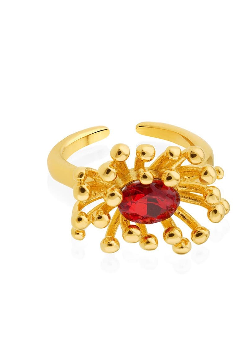Close-up of ruby red zircon sunburst ring in 18K gold plating
