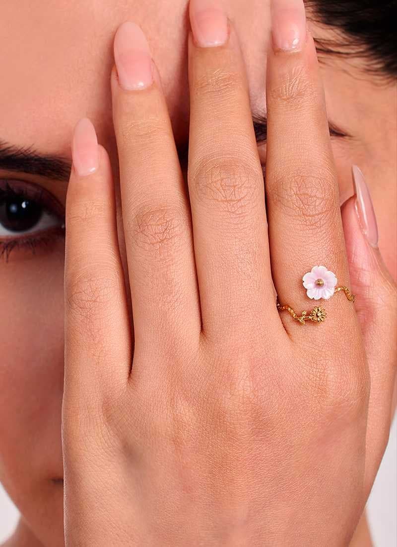 Close-up look on model wearing golden flora ring by elra