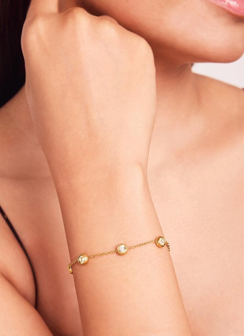 Close-up of 18k gold plated bracelet with five sparkling bezel stones