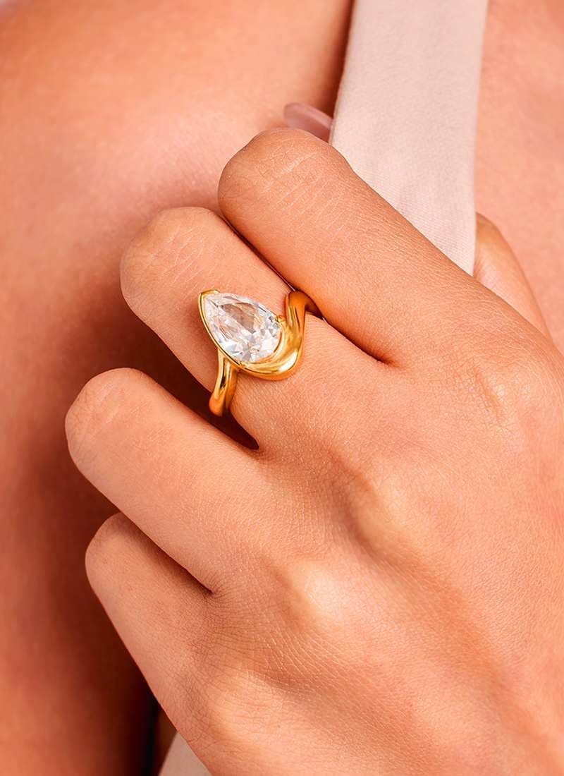 Close-up of teardrop cut stone ring in 18K gold plating