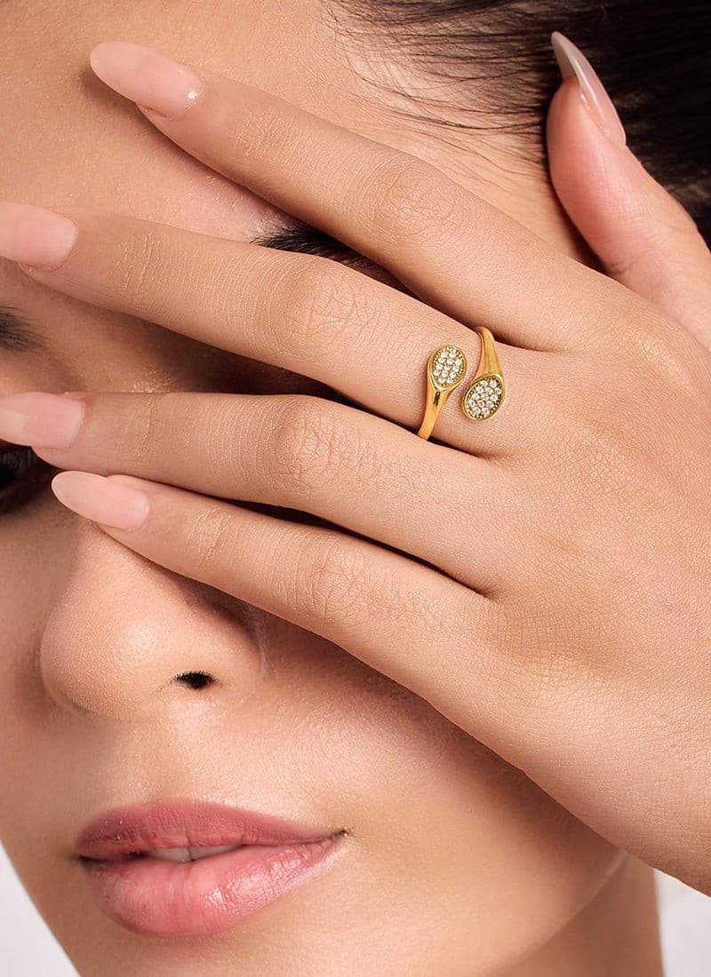 Close-up of zircon studded loop ring in 18K gold plating